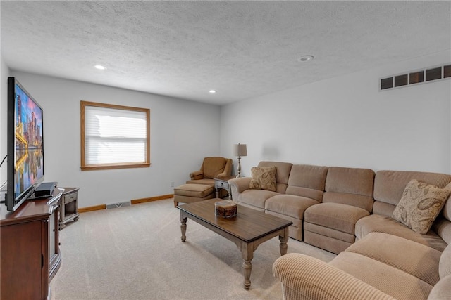 living room featuring baseboards, visible vents, light colored carpet, a textured ceiling, and recessed lighting