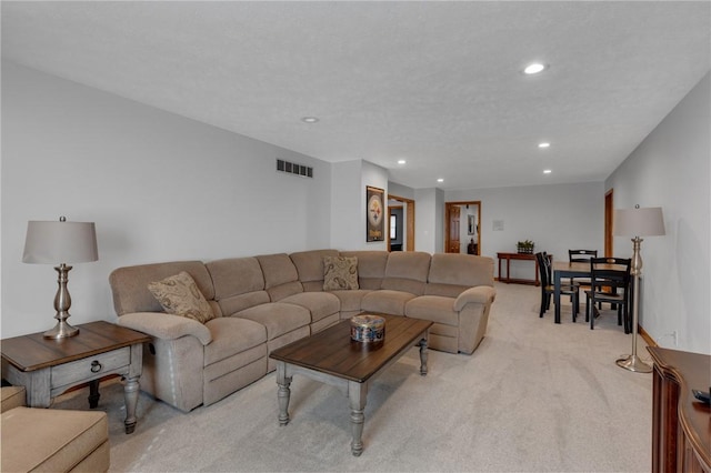 living room featuring recessed lighting, visible vents, and light colored carpet