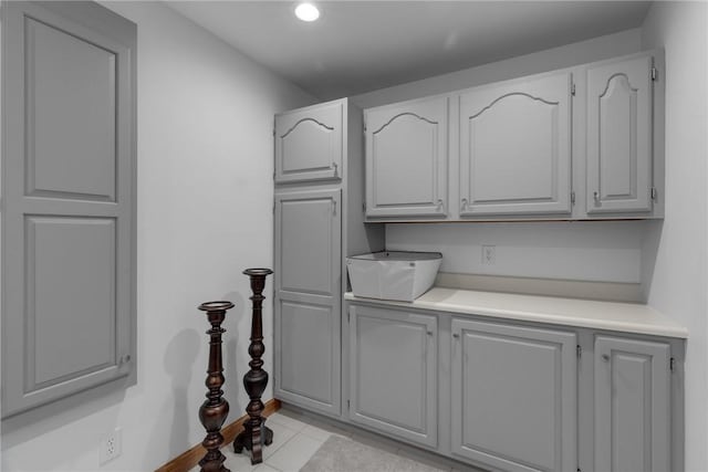 kitchen with light tile patterned floors, light countertops, and gray cabinets