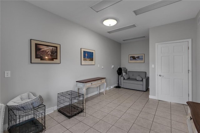 sitting room featuring light tile patterned floors, visible vents, and baseboards