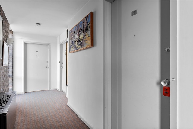 hall with carpet floors and baseboards