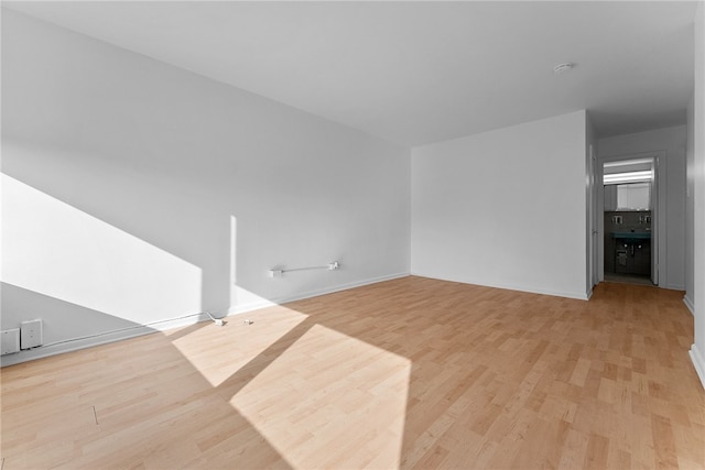 unfurnished living room featuring light wood-style floors and baseboards