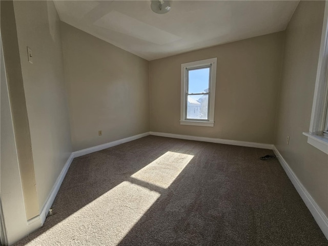 unfurnished room featuring carpet floors and baseboards