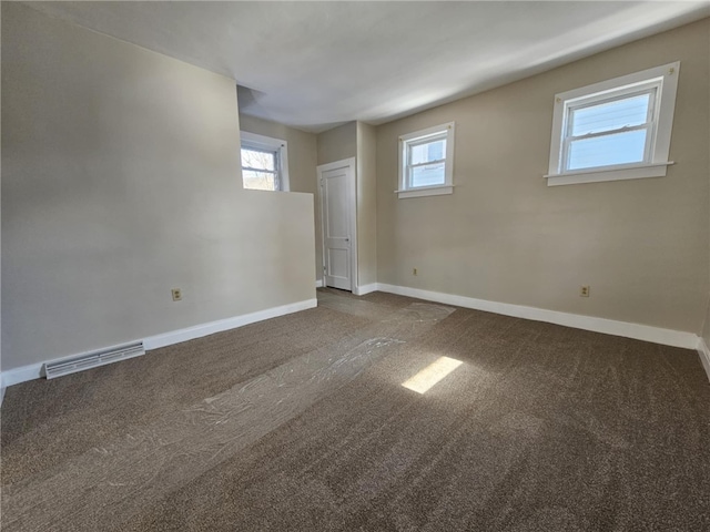 carpeted empty room with visible vents and baseboards