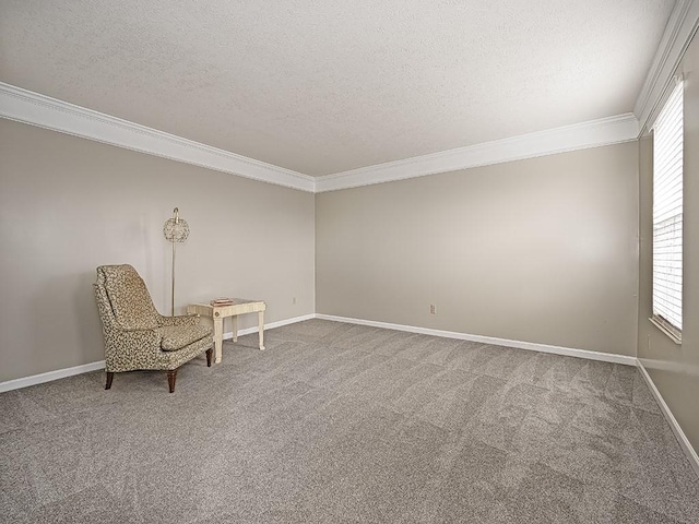 unfurnished room featuring ornamental molding, carpet flooring, a textured ceiling, and baseboards