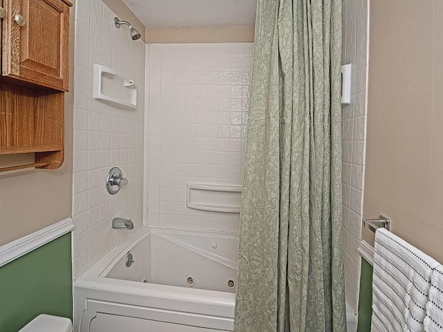 bathroom with a combined bath / shower with jetted tub