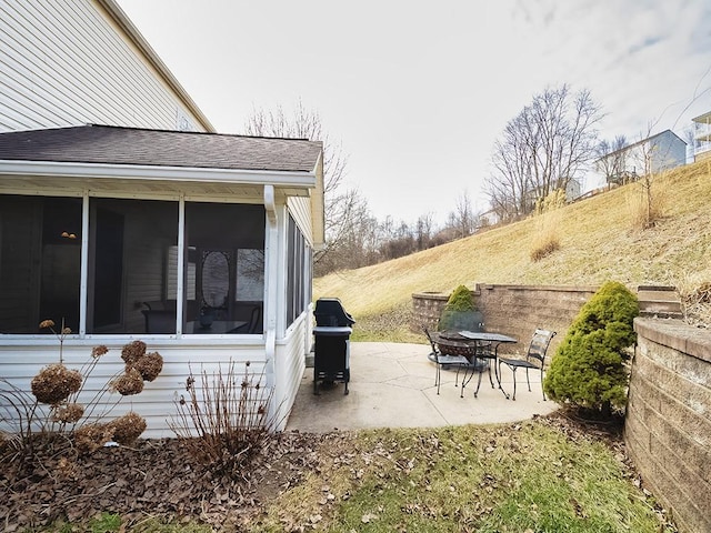 view of patio with a sunroom and area for grilling