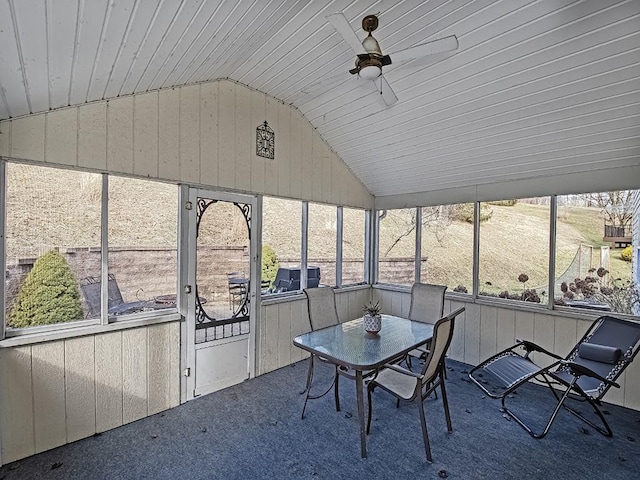 unfurnished sunroom featuring lofted ceiling, wood ceiling, and a ceiling fan