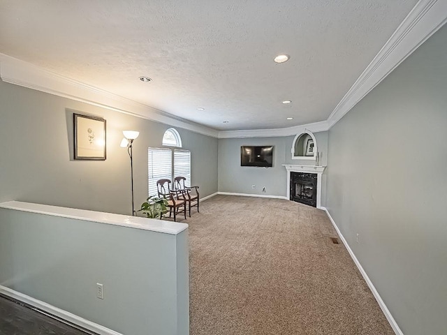 unfurnished room featuring ornamental molding, carpet, a fireplace, and a textured ceiling