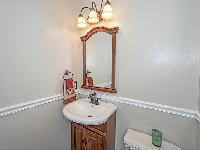 bathroom featuring toilet and vanity