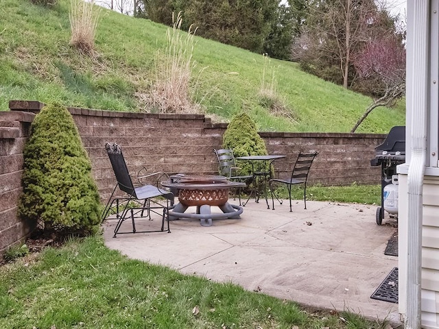 view of patio / terrace with an outdoor fire pit and fence