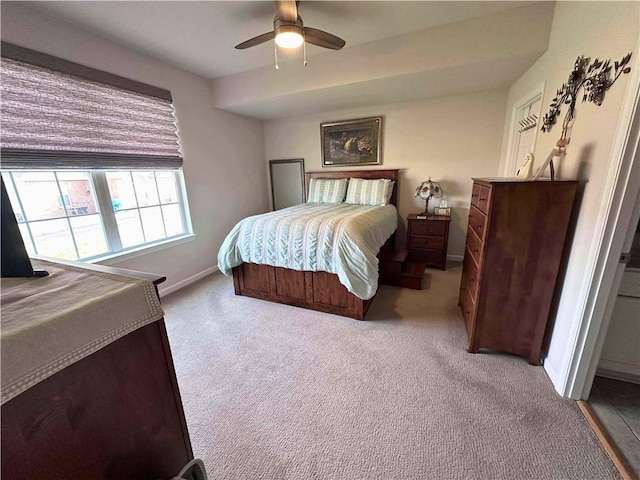 carpeted bedroom with ceiling fan and baseboards