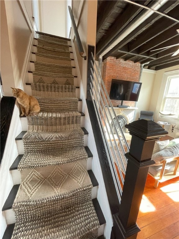 staircase featuring wood finished floors