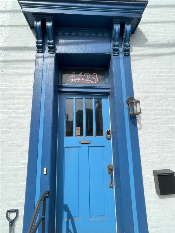 view of exterior entry with brick siding