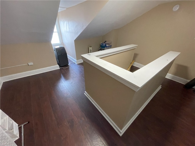 bonus room with lofted ceiling, dark wood finished floors, and baseboards