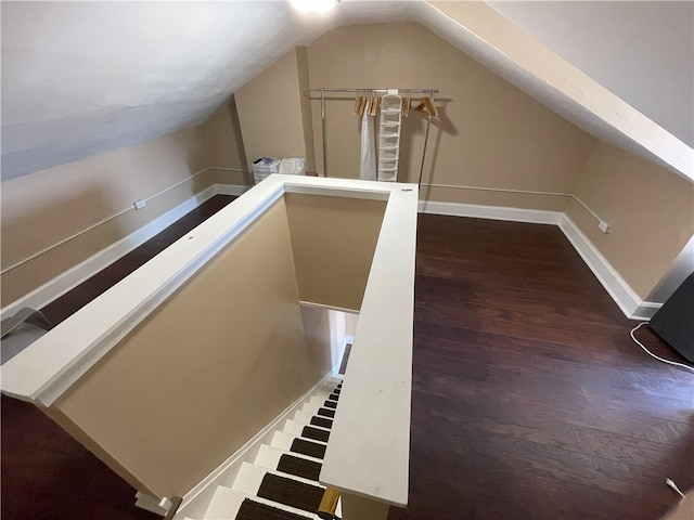 additional living space with lofted ceiling, baseboards, and wood finished floors