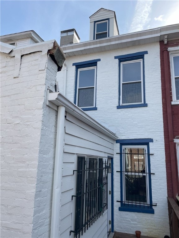 view of property exterior featuring brick siding