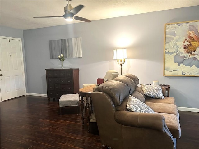 living area with a ceiling fan, baseboards, and wood finished floors