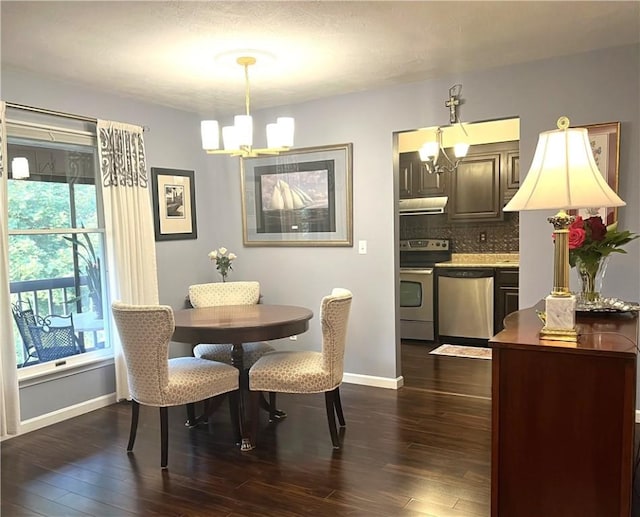 dining area featuring a chandelier, dark wood finished floors, and baseboards