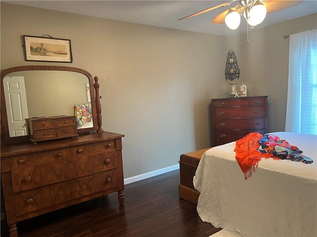 bedroom featuring dark wood-style floors, ceiling fan, and baseboards