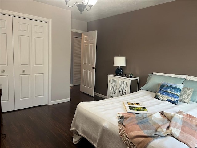 bedroom with a closet, wood finished floors, and baseboards