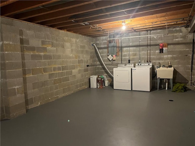 unfinished basement with washing machine and dryer and a sink