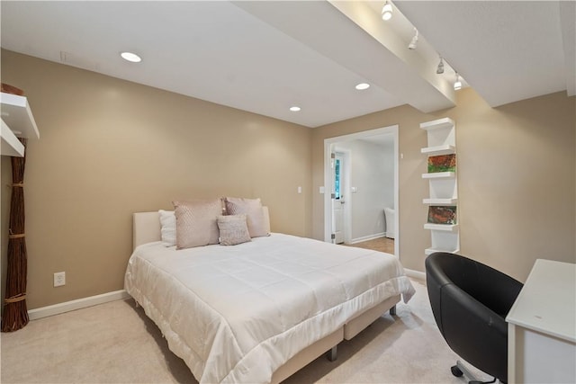 bedroom featuring baseboards, track lighting, recessed lighting, and light colored carpet