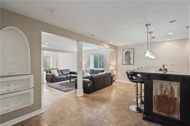 living room with bar, visible vents, baseboards, and recessed lighting