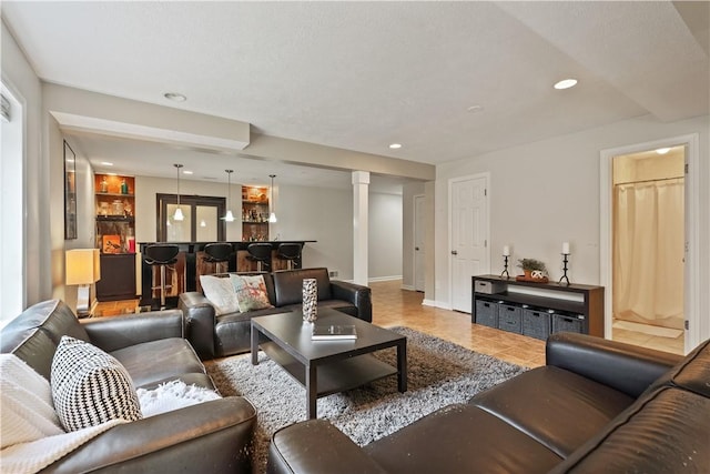 tiled living area with recessed lighting, baseboards, and a bar