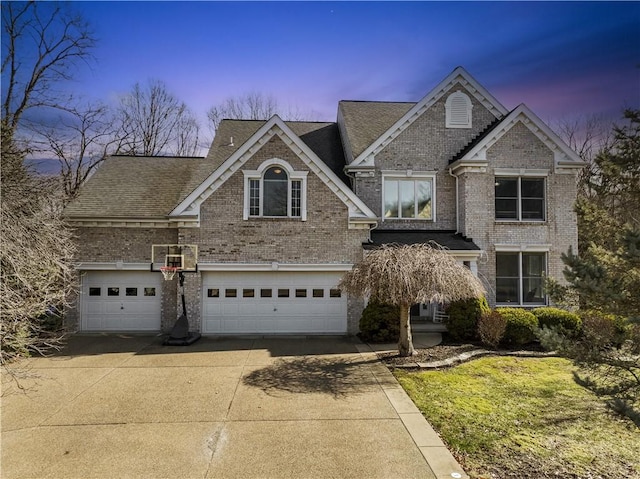 traditional home with a garage, a front lawn, concrete driveway, and brick siding