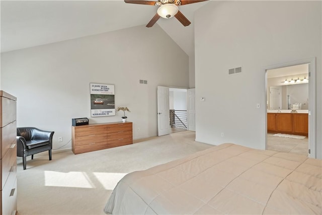 bedroom featuring high vaulted ceiling, visible vents, and light carpet