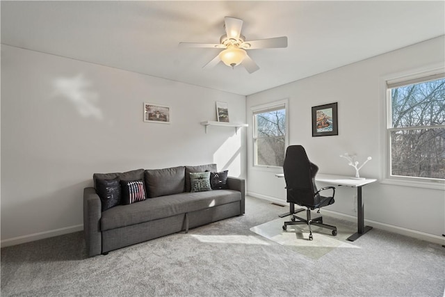 carpeted office space with a healthy amount of sunlight, ceiling fan, and baseboards