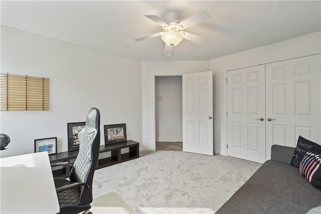 carpeted office featuring a ceiling fan