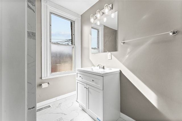 bathroom with marble finish floor, visible vents, vanity, and baseboards