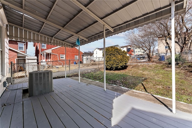 wooden terrace with fence, a residential view, and central air condition unit