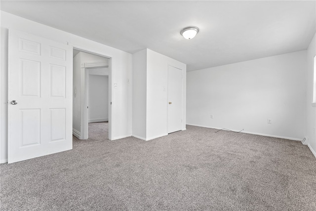 unfurnished bedroom featuring carpet floors and baseboards