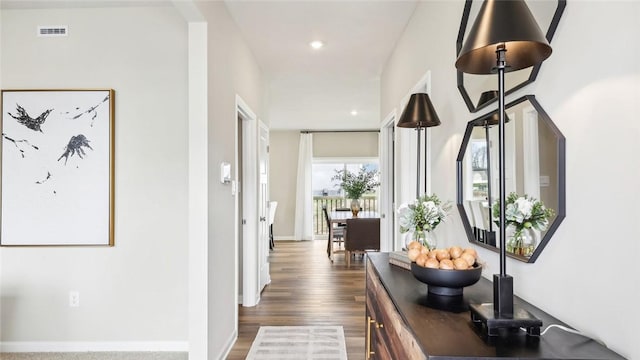 hall featuring recessed lighting, baseboards, visible vents, and dark wood finished floors