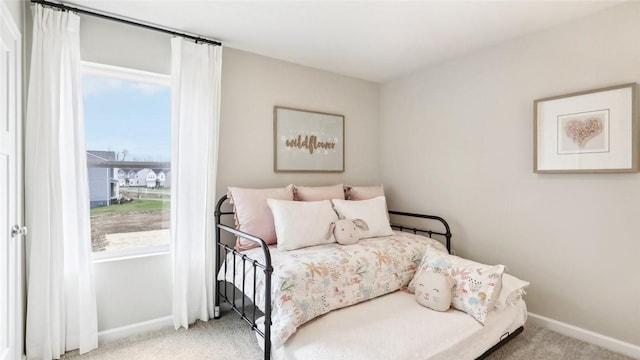 carpeted bedroom with baseboards and multiple windows