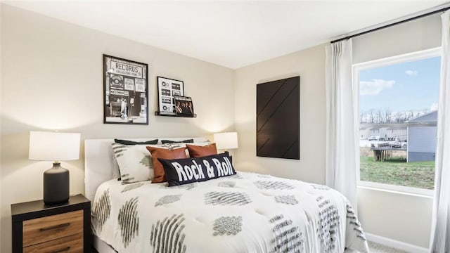 carpeted bedroom featuring baseboards
