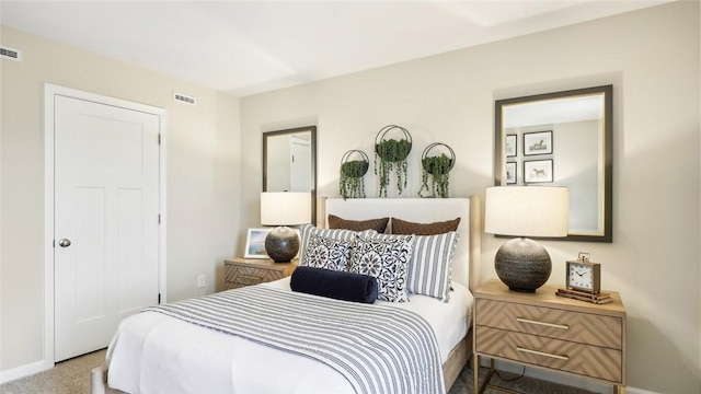 carpeted bedroom with baseboards and visible vents
