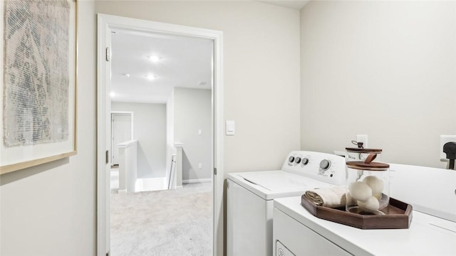 laundry area featuring separate washer and dryer, laundry area, and carpet floors