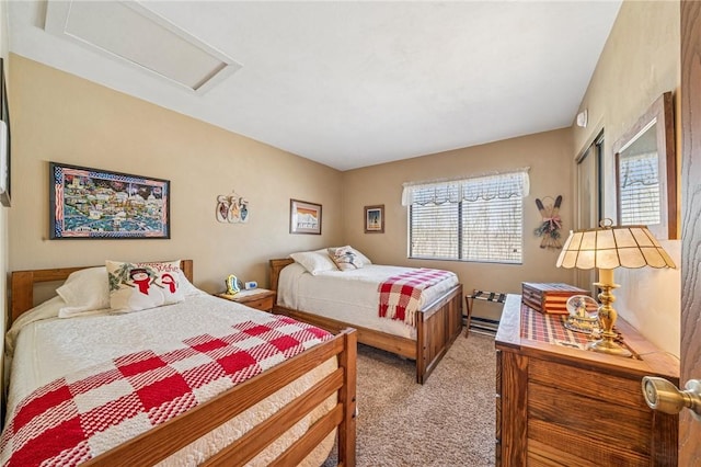 bedroom with attic access and light carpet