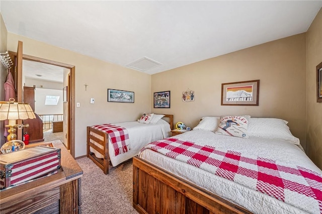 carpeted bedroom featuring attic access