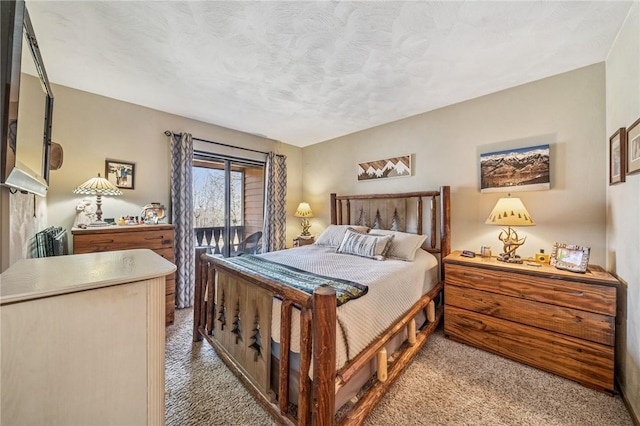 bedroom with a textured ceiling and carpet flooring