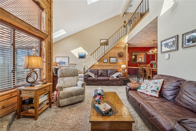 carpeted living room with plenty of natural light, stairway, and a towering ceiling