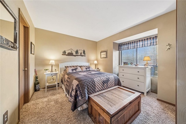 bedroom with baseboards and light colored carpet