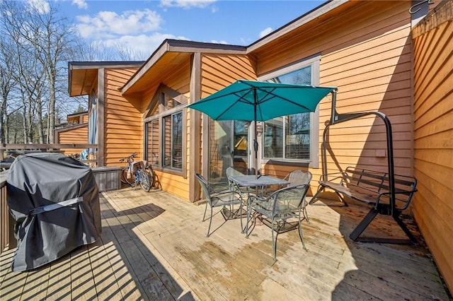 wooden deck featuring outdoor dining area and grilling area