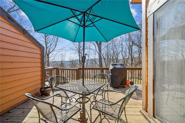 wooden terrace featuring outdoor dining area