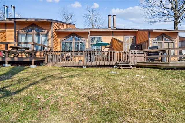 rear view of house featuring a yard and a wooden deck