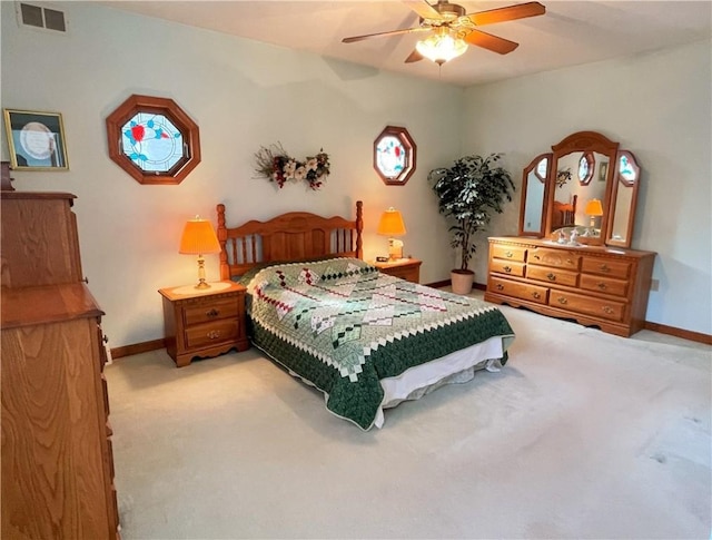 bedroom with baseboards, visible vents, and light colored carpet